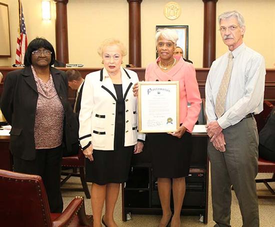 Freeholder Lillian G. Burry presented a proclamation for Fair Housing Month to (from left to right) Mary Lee Gilmore, Cheryl Finley and Owen Redmond.